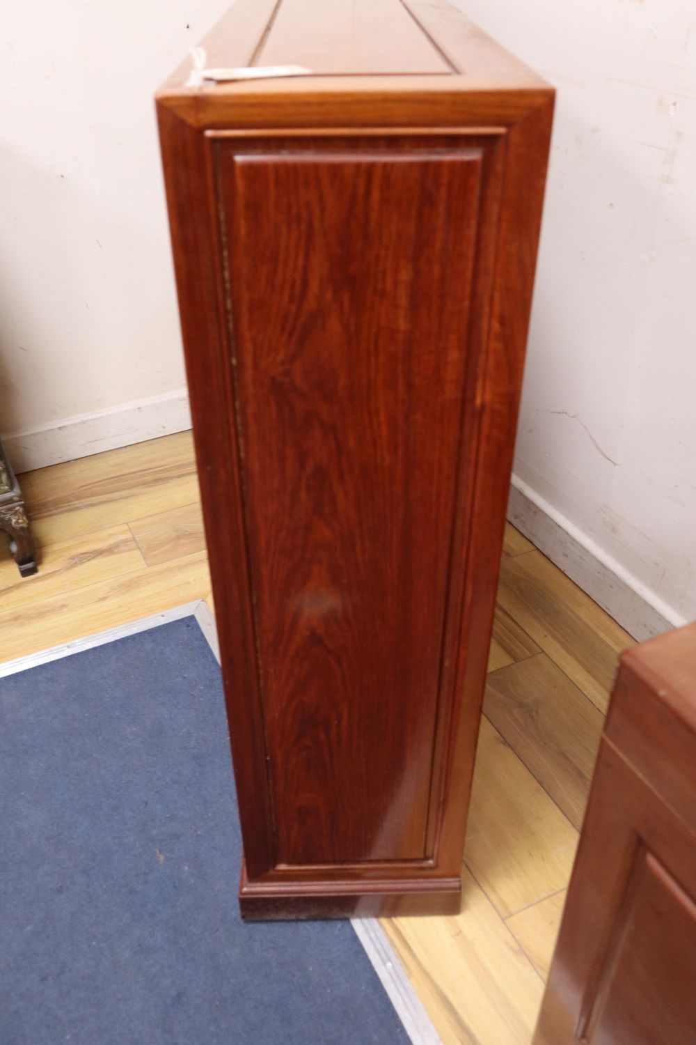 A Chinese hardwood open bookcase, width 122cm, depth 25cm, height 91cm